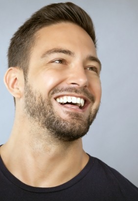 Man with perfectly aligned smile after orthodontic treatment