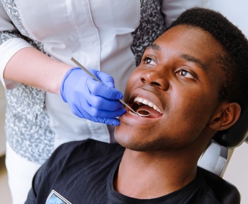 Man receiving preventive dentistry checkups and teeth cleanings