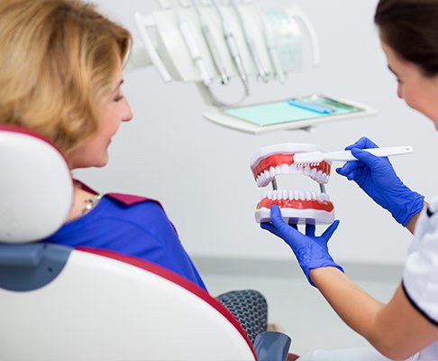 Dentist showing dental patient a smile model