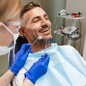 man at a checkup with his implant dentist in Southlake