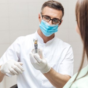 Dentist discussing a dental implant with patient