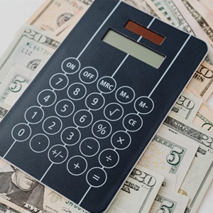 Cash and calculator on white background