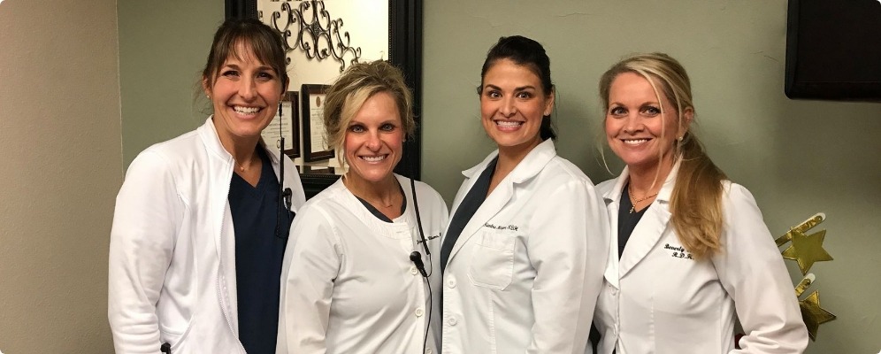 Four smiling dental hygienists in Southlake Texas