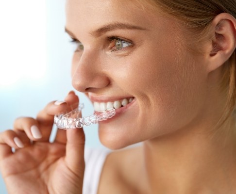 Dental patient placing an Invisalign tray