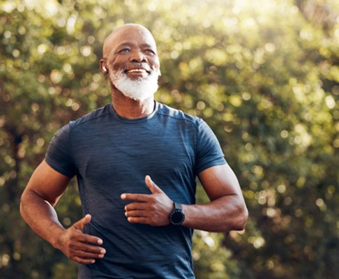 Bearded man in blue shirt outside and jogging