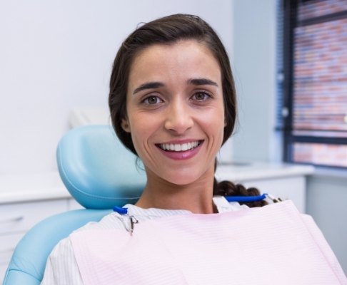 Woman smiling after dental treatment under general anesthesia