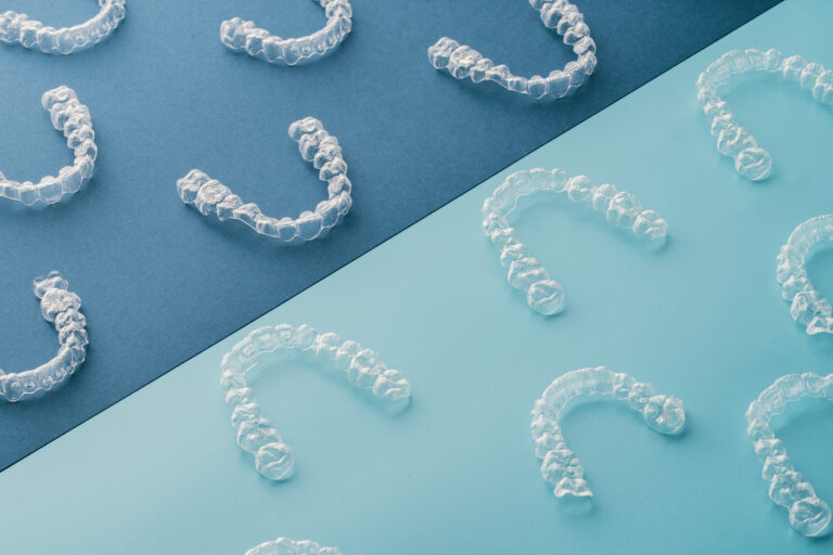 Invisalign aligners on a green and blue background